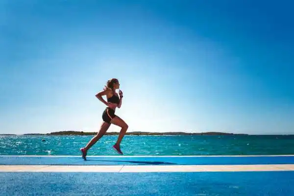 Woman running showing strong leg muscle Salford Priors